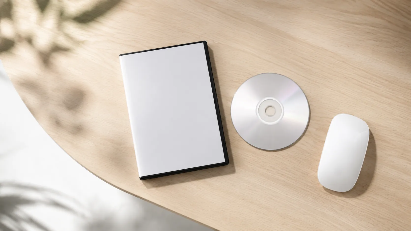 DVD case and disc on wooden desk prepared for burning subtitles on Mac