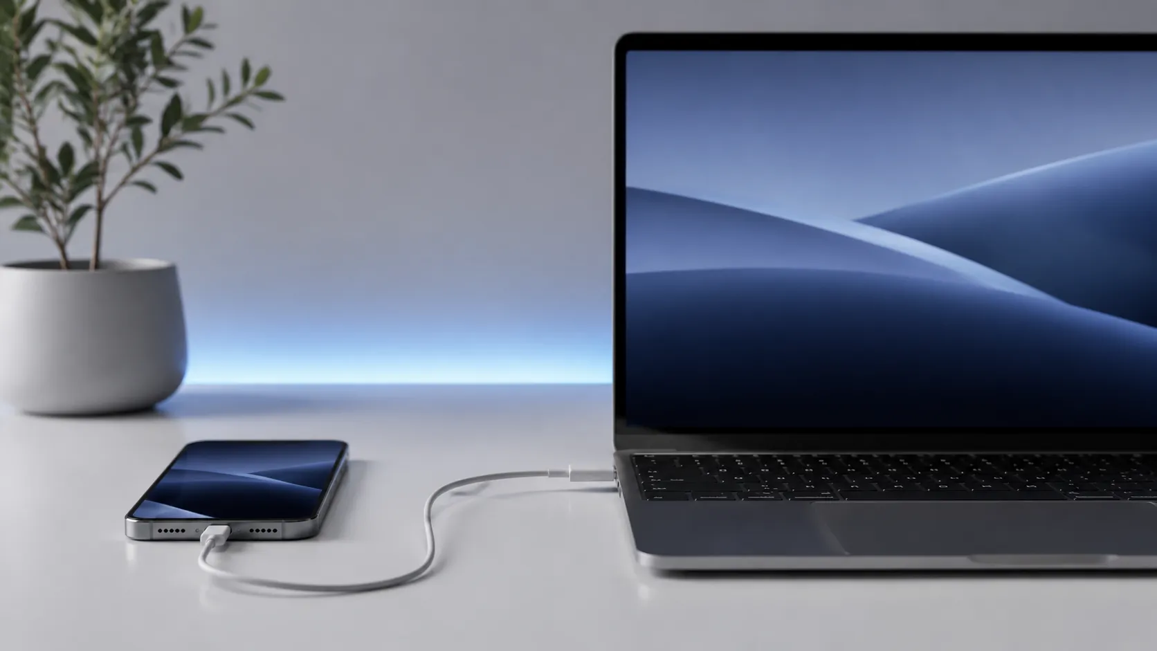iPhone connected to Mac via USB-C cable for music syncing using an iTunes alternative app