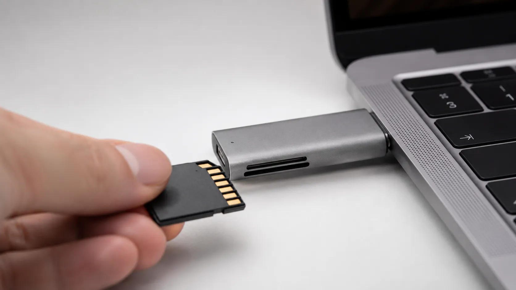 SD card inserted into USB-C card reader attached to MacBook Air for fast video import